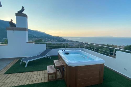 a hot tub on the balcony of a house at Loft incantevole con idromassaggio esterno privato in Patti
