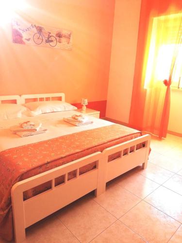 a bedroom with a large bed with a table at Il sole in Maruggio