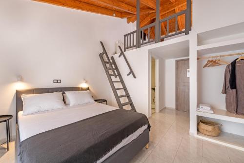 a bedroom with a bed and a ladder in a room at Costa Azzurra Hotel in Skala Kefalonias