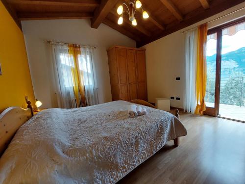 a bedroom with a bed and a large window at Casa Graziella in Malcesine