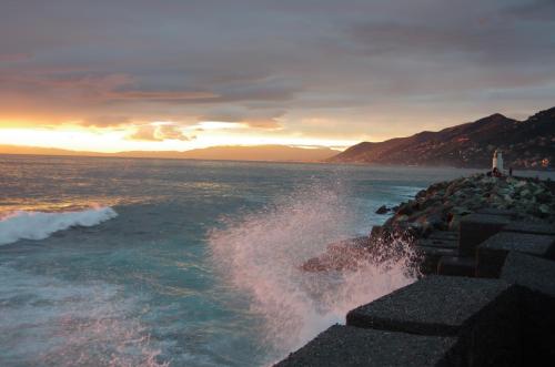 a wave crashing on a rock in the ocean at Stella Marina in Camogli