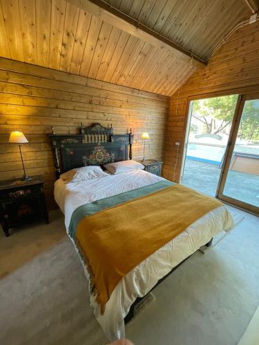 a bedroom with a large bed with a wooden wall at Casa Paloma in Comporta