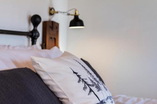 a bedroom with a bed with a pillow and a lamp at Casale Le Brecce in Otricoli