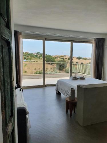 a bedroom with a bed and a large window at Casa Lunaria B&B in Porto SantʼElpidio