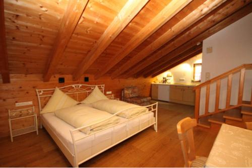ein Schlafzimmer mit einem weißen Bett und einer Holzdecke in der Unterkunft Haus Dananic in Anger