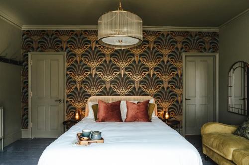 a bedroom with a large bed with red pillows at The fig in Rye