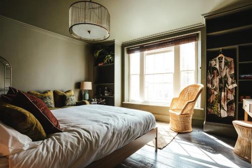 a bedroom with a bed and a window and a chair at The fig in Rye