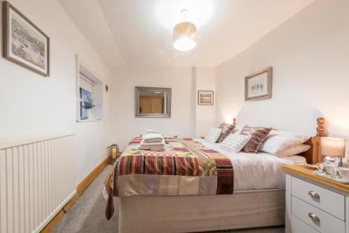 a bedroom with a bed and a sink at Harper’s Cottage, Fence, Lancashire in Brierfield