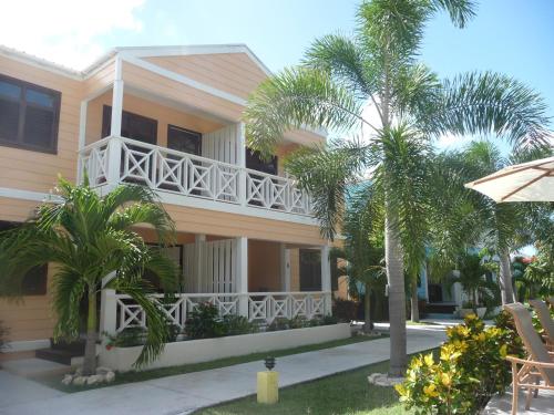 a building with a balcony and palm trees at Buccaneer Beach Club in Dickenson Bay