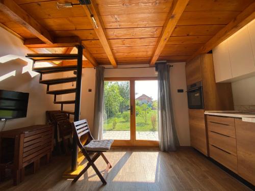 eine Küche mit einer Holzdecke und einer Wendeltreppe in der Unterkunft Petrovaradin Chalet in Novi Sad