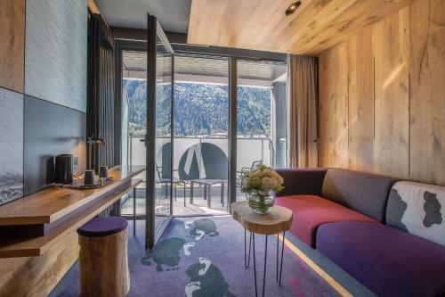 a living room with a couch and a table at Alpina Eclectic Hotel in Chamonix-Mont-Blanc