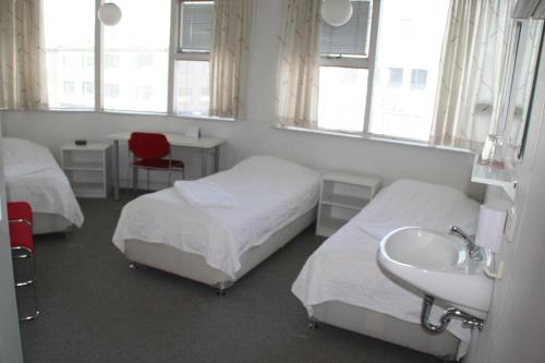 a hospital room with two beds and a sink at 101 Guesthouse Hotel in Reykjavík