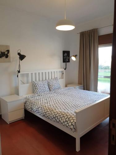 a bedroom with a white bed and a window at Vale do Sol in Albufeira