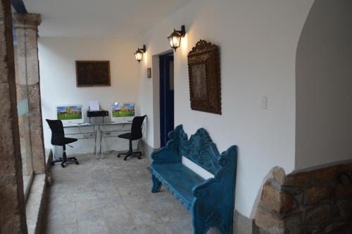 a living room with a blue couch and a desk at Tierra Viva Cusco San Blas in Cusco