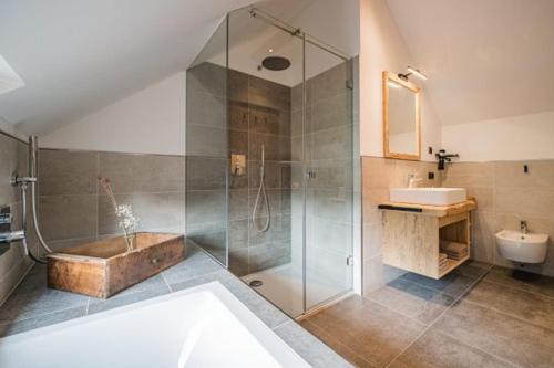 a bathroom with a shower and a tub and a sink at Ausserwegerhof in Anterselva di Mezzo