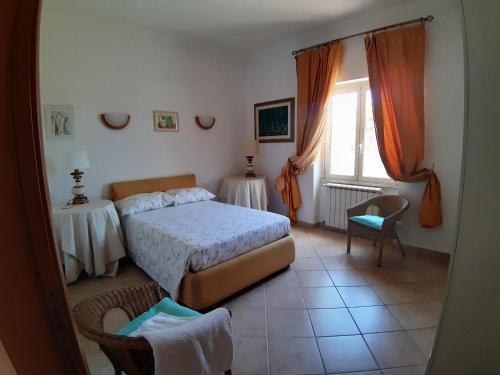 a bedroom with a bed and a window at Villino dei Coralli in Lido di Ostia
