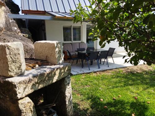 a patio with a table and chairs in front of a house at Casa Independiente Bella Vista in Moaña