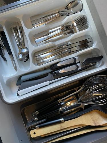 a drawer filled with silver utensils in a drawer at Atelier Voyageur in Chartres