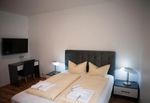 a bedroom with a bed with two towels on it at Wiesentäler Hof Hotel garni in Konstanz