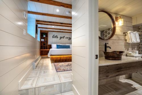 a bathroom with a sink and a bed in a room at The Barnstead Inn in Manchester Center