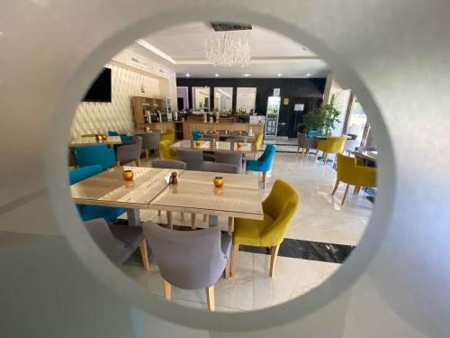 a view of a restaurant with tables and chairs at Hotel Nevada in Constanţa
