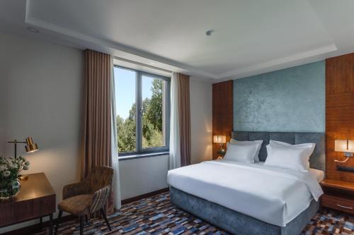 Postel nebo postele na pokoji v ubytování ATECA Hotel Suites Tashkent