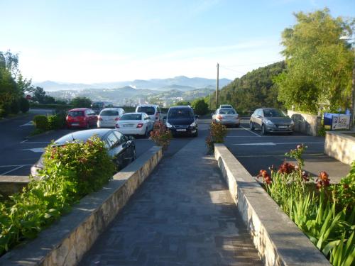 a street with cars parked in a parking lot at Hotel Leku Eder in Donostia-San Sebastián