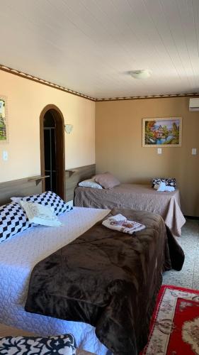 a room with two beds in a room at Hotel Dom Daniel in Palmares