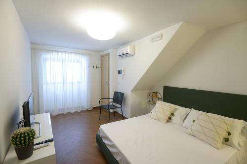 a bedroom with a bed with a green headboard at San Domenico in Bari