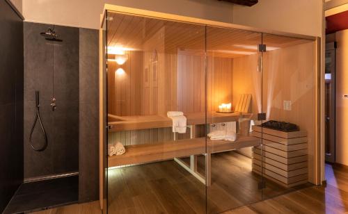 a bathroom with a shower and a tub at Hotel Leon D'Oro in Orta San Giulio