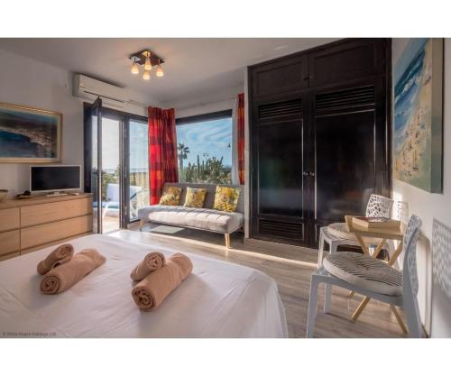 a bedroom with a bed with towels on it at Puerto Chico I and J in Playa Blanca
