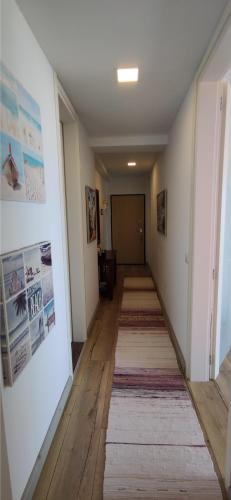 a long hallway with a rug on the floor and a hallway sidx sidx at Luxury Beach Apartment in Qerret in Golem