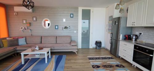 a living room with a couch and a table at Luxury Beach Apartment in Qerret in Golem