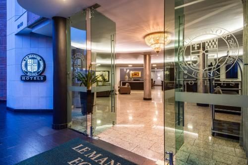 a lobby of a hotel with a glass door at Hotel Egina Medellin in Medellín