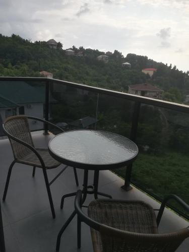 a table and chairs on a balcony with a view at Boutique Hotel Sleep and Wine in Batumi