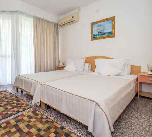 um quarto de hotel com duas camas e uma janela em Hotel Raluca em Venus