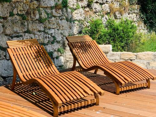 two wooden benches sitting on a wooden deck at Jagdschloß Walkenried in Walkenried