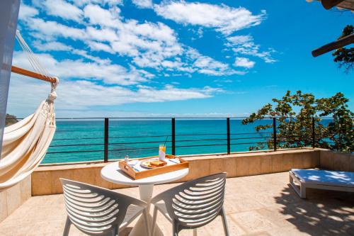 a balcony with a view of the ocean at Aria By LD Hotel Boutique in Pampatar