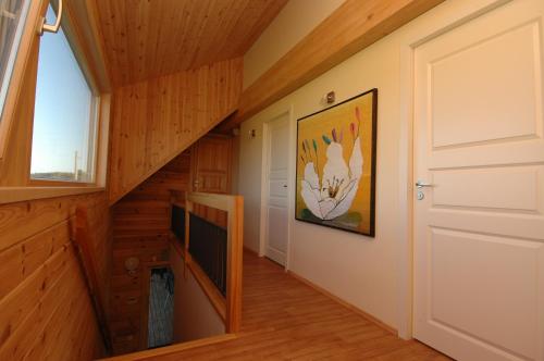a staircase in a log cabin with a door and a window at Villa Medeina in Šventoji