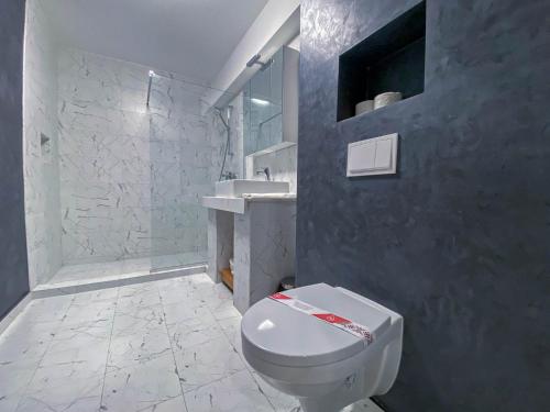 a bathroom with a white toilet and a sink at Aparthotel Nevada - Apartamente in Constanţa