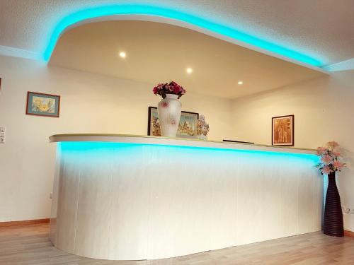 a blue lighted bar in a room with a counter at Pension Cao Lai in Varel