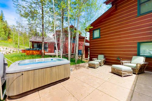 a hot tub sitting on a patio next to a house at Moose Creek 26 in Teton Village