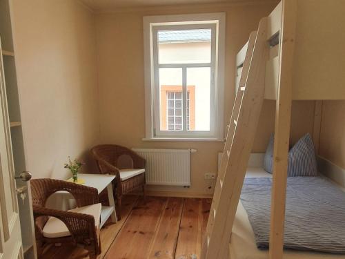a small room with a bunk bed and a window at Altes Pfarrhaus Neustädt in Neustädt