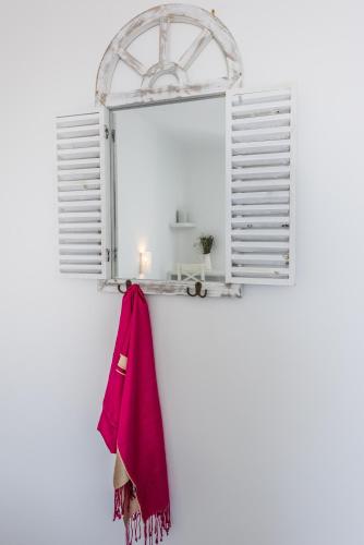 a towel hanging on a wall with a window at Blu Suites and Studios in Adamas
