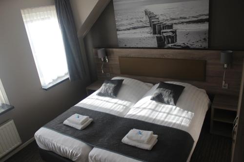 Postel nebo postele na pokoji v ubytování Hotel Restaurant 't Klokje