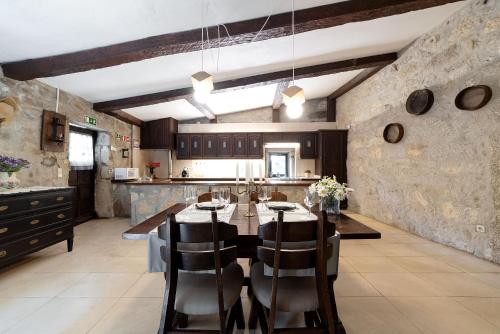 a kitchen and dining room with a table and chairs at Neiva River House - Azenha Next to the River in Esposende