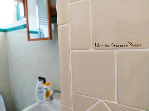 a bathroom with a sign on the wall above a sink at Stanze Don Gesualdo Alloggio Turistico in Taurasi