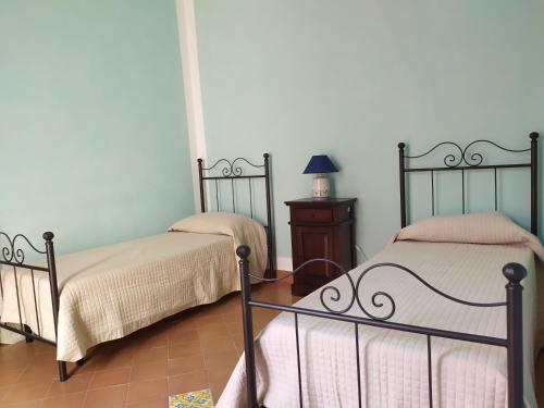 two beds sitting next to each other in a room at Stanze Don Gesualdo Alloggio Turistico in Taurasi