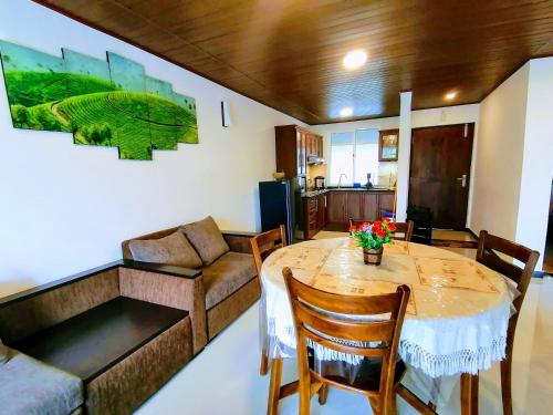 a living room with a table and a couch at Moon Plains Luxury Apartments in Nuwara Eliya