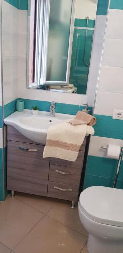 ein Badezimmer mit einem Waschbecken, einem WC und einem Spiegel in der Unterkunft casa anna in Vico Equense